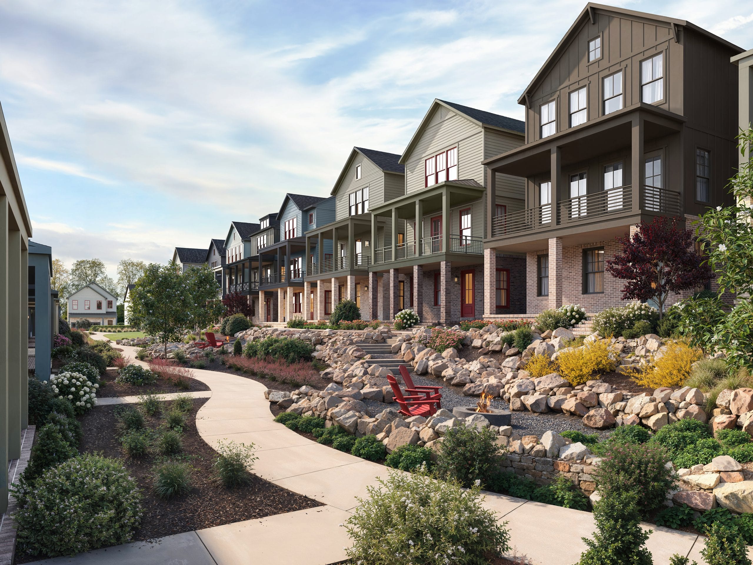 Row of modern multi-story houses with front porches, landscaped gardens, curved sidewalk, and red chairs, clear sky with some clouds.